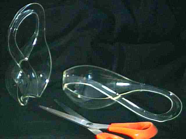 Two matching halves of a Klein Bottle, with a scissors
