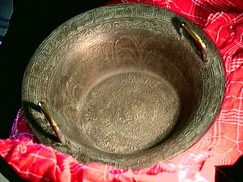 Big Spouting Bowl (Chinese Singing Bowl) agains a red & black background