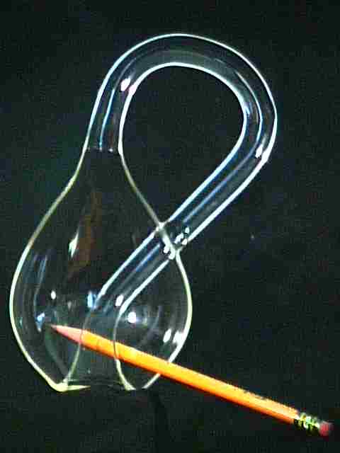 Klein Bottle sliced down the middle, with a pencil inside.  See the Moebius Strip along the edge.